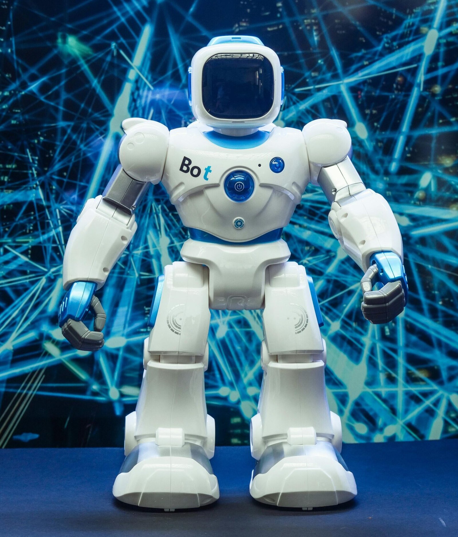 Futuristic humanoid robot against a blue network pattern backdrop, showcasing modern technology.